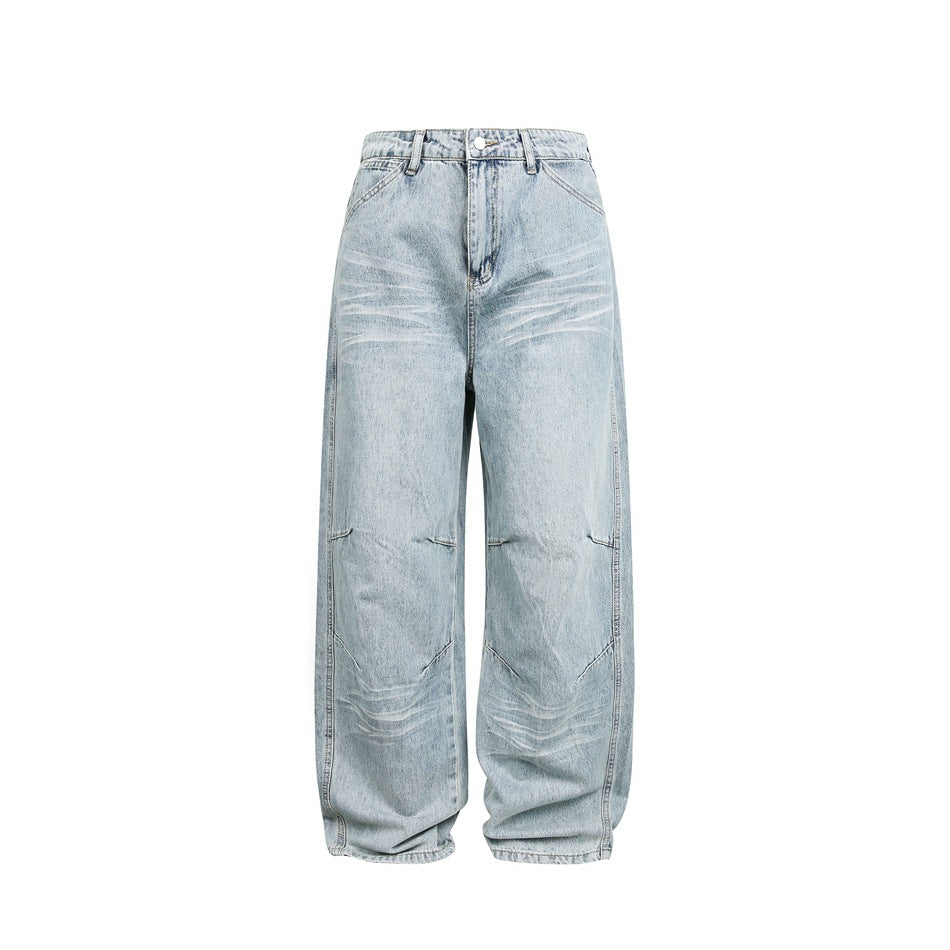 Front view of loose light-wash jeans with whiskering, articulated knee seams, and a button fly on a white background.