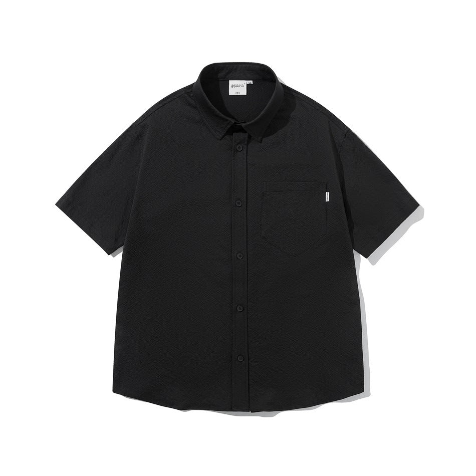 Black short-sleeve button-up shirt with chest pocket and textured fabric, flat front view