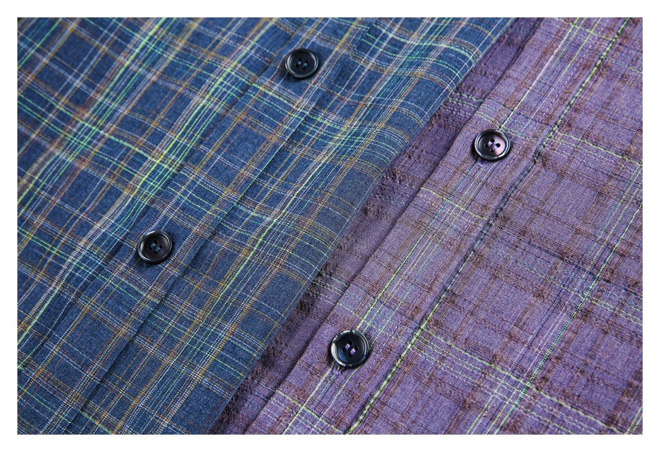 Close-up of blue and muted purple plaid shirt fabrics with multicolored checks and dark buttons.