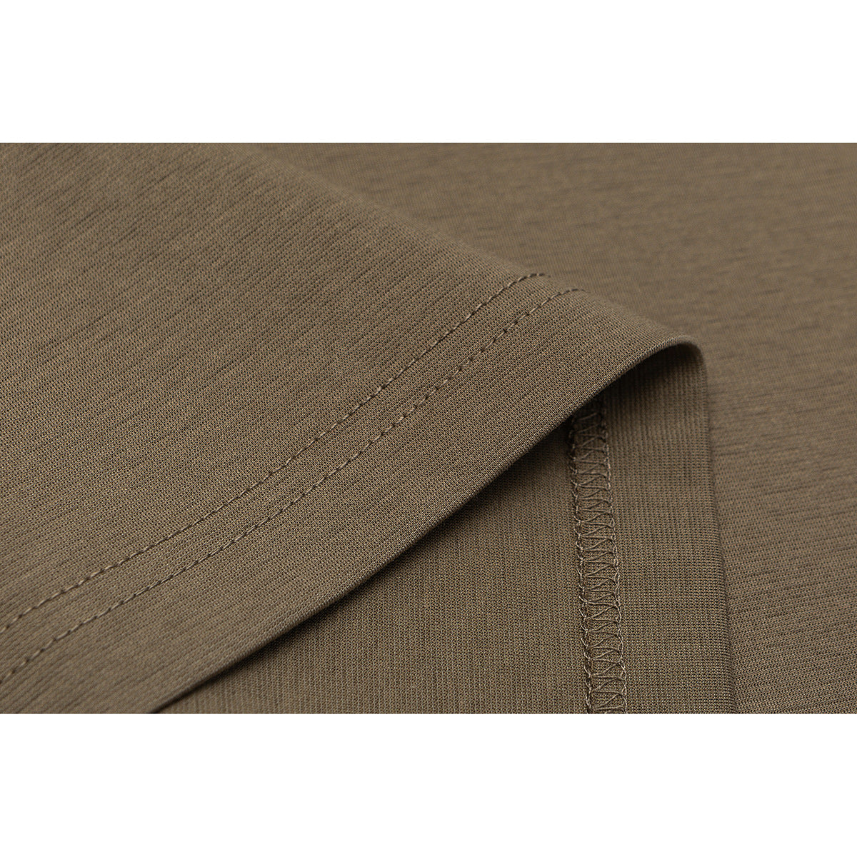Close-up of the brown T-shirt's sleeve hem and overlocked seam.