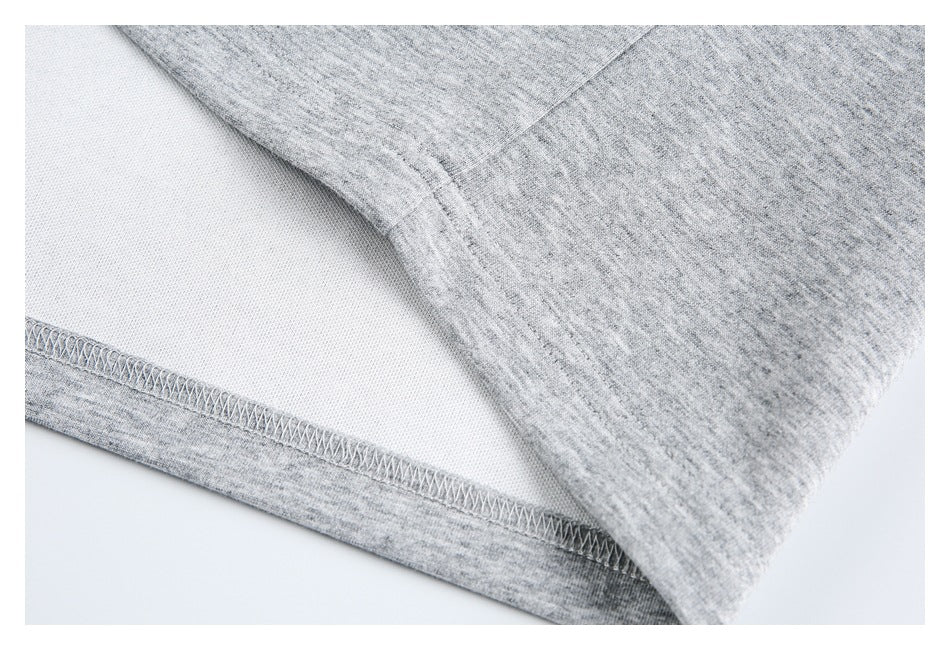 Inside close-up showing the overlocked stitching along a gray garment hem.