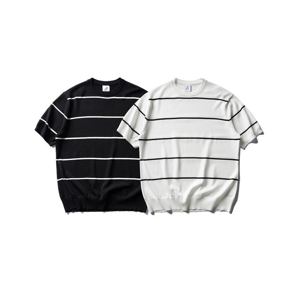 Front view of two short-sleeve crew-neck knit tops: one black with ivory stripes and one ivory with black stripes.