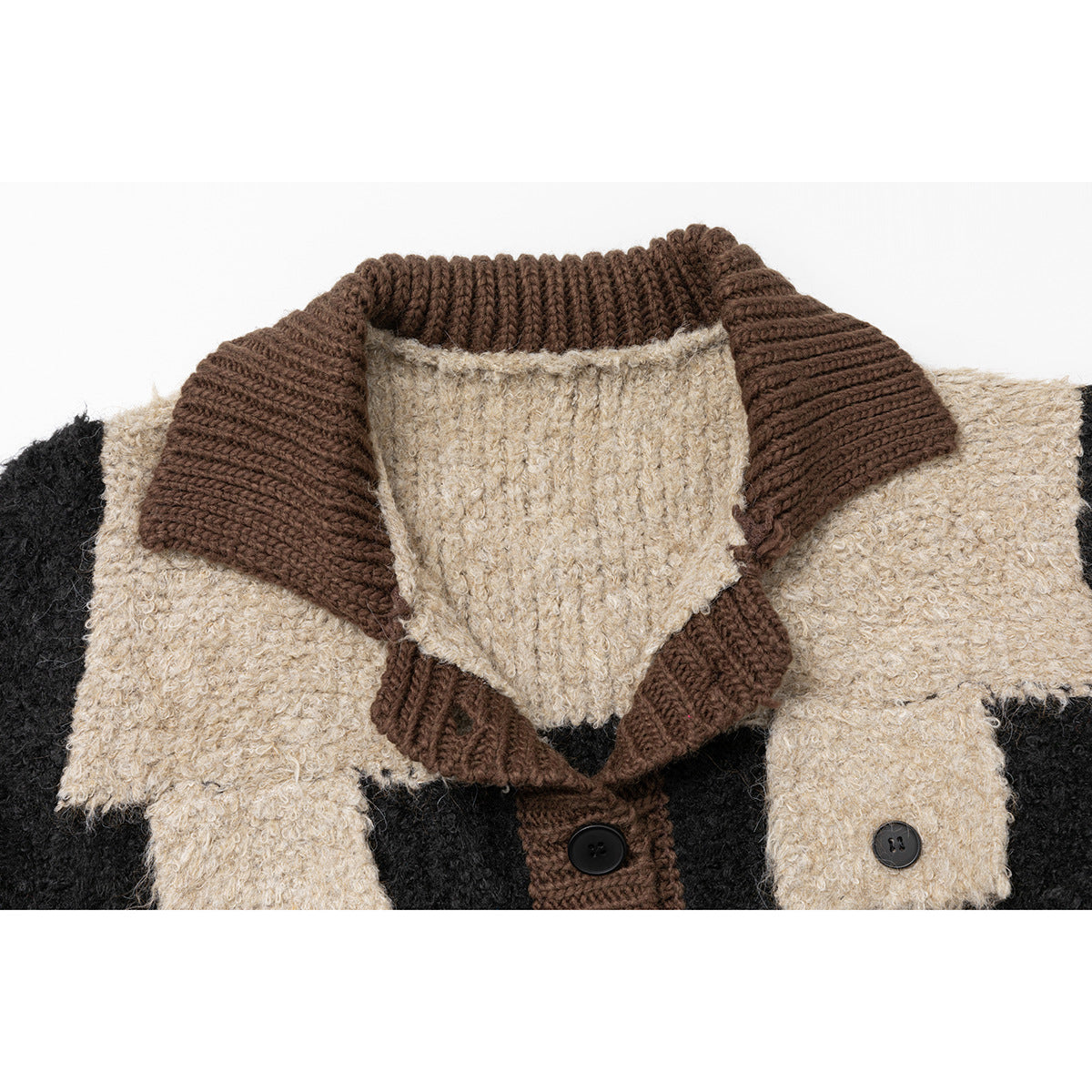 Close-up of a black, cream, and brown knit cardigan showing its wide brown collar and buttoned front.