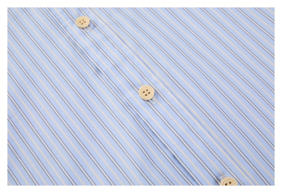 Close-up of a light blue shirt with narrow white and tan stripes and beige buttons on the placket.