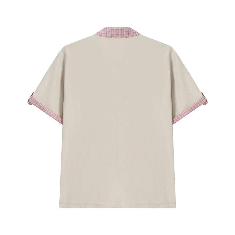 Back view of beige short-sleeve polo top with pink plaid collar edge and turn-up plaid cuffs