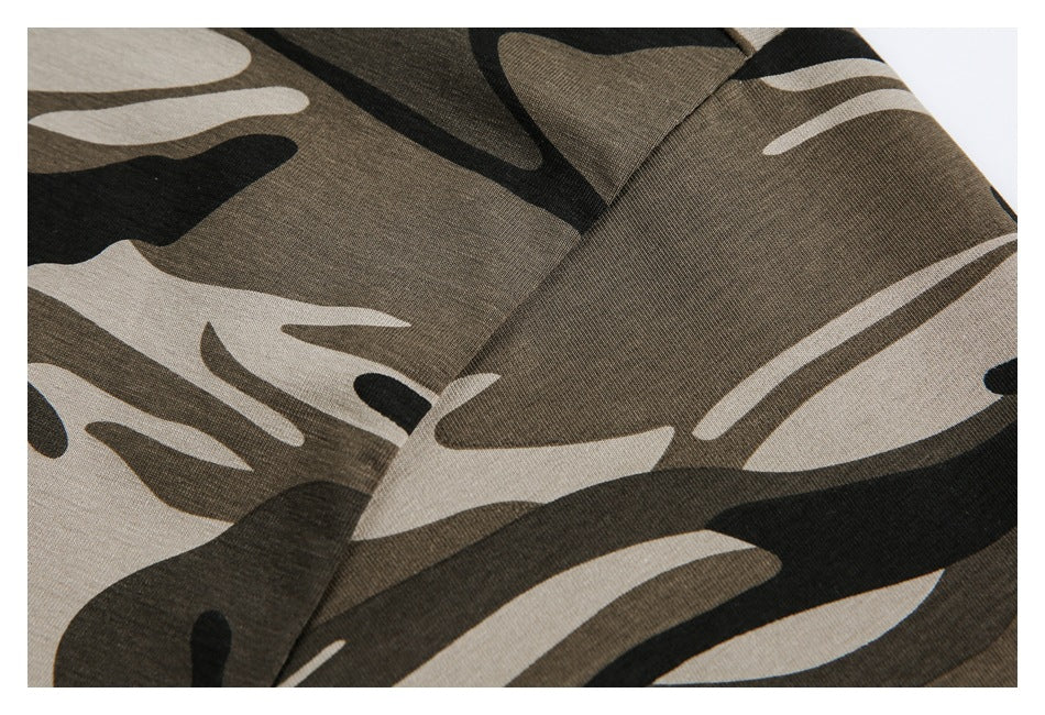 Close-up of brown, black, and beige camouflage fabric with a diagonal stitched seam.