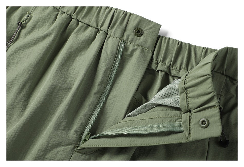 Close-up of the skirt's snap waistband and opened fly, showing the zipper and inner mesh lining.