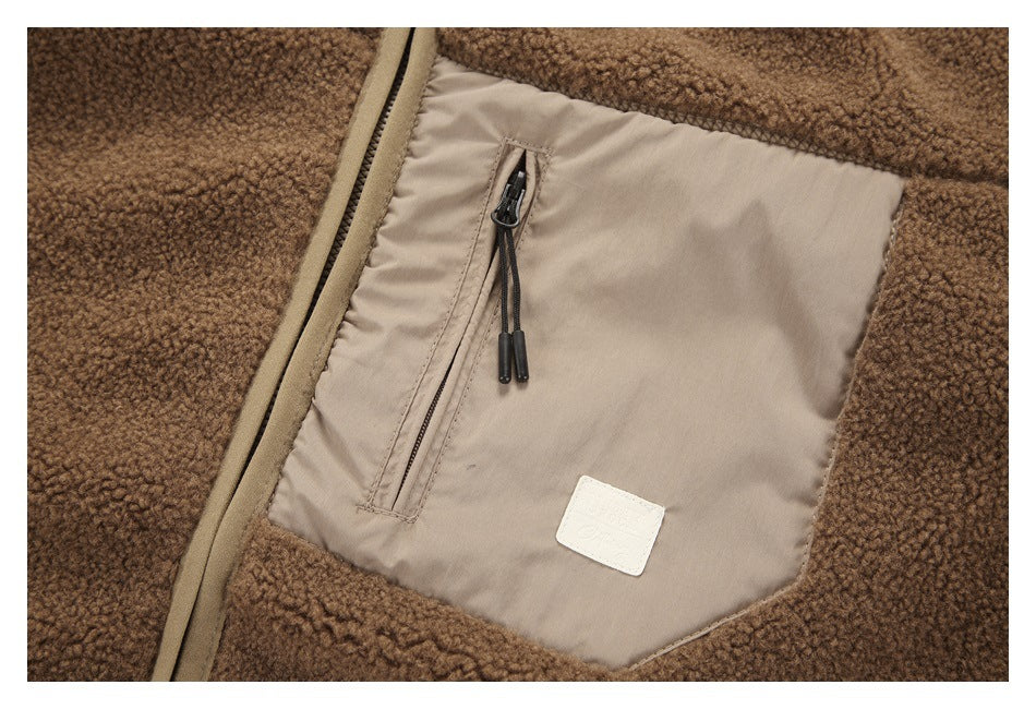 Close-up of a beige-lined pocket with a narrow zipper on a brown fleece jacket.