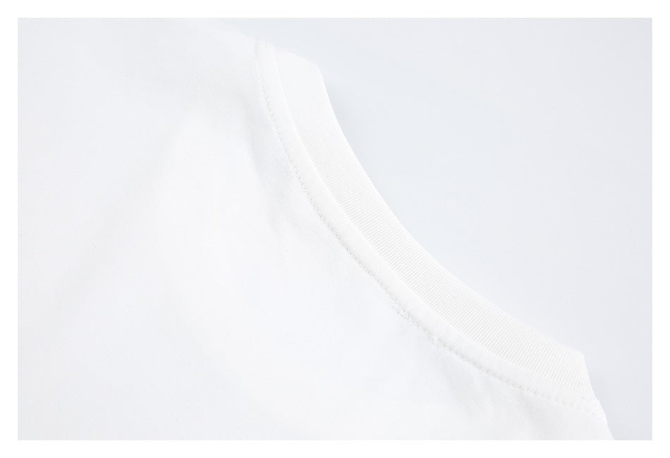 Close-up of a white garment's curved ribbed neckline and stitching.