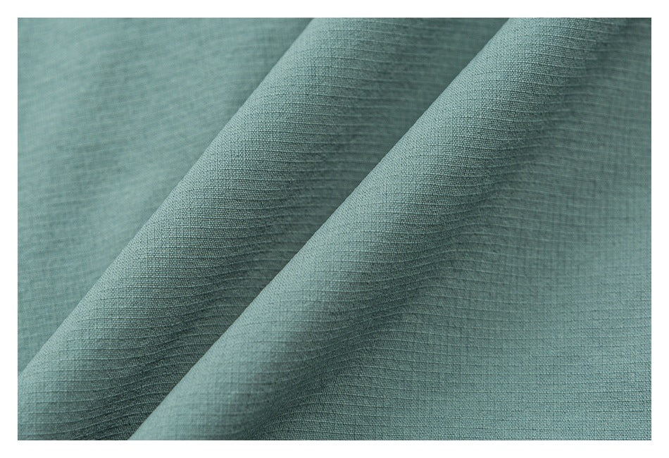 Extreme close-up of the textured surface of mint-green shorts fabric.