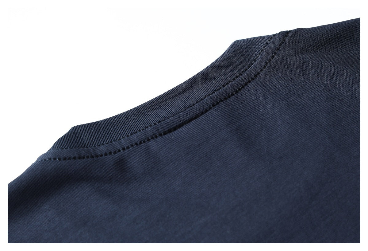 Close-up of a dark navy garment's ribbed crew neckline and stitching against a white background.