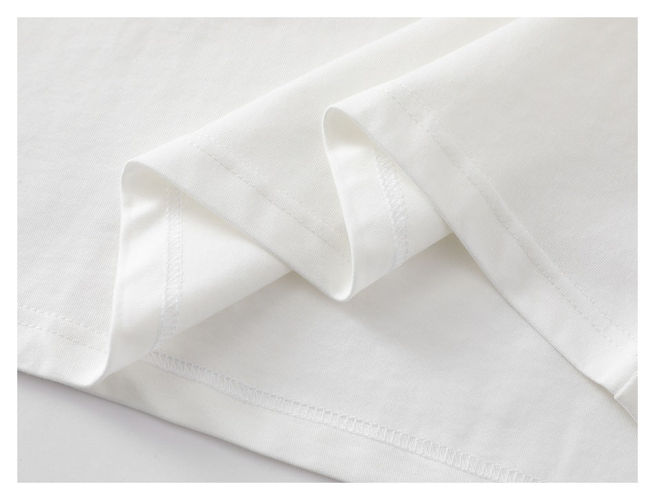 Close-up of the white garment hem, showing folded edges and overlock stitching.
