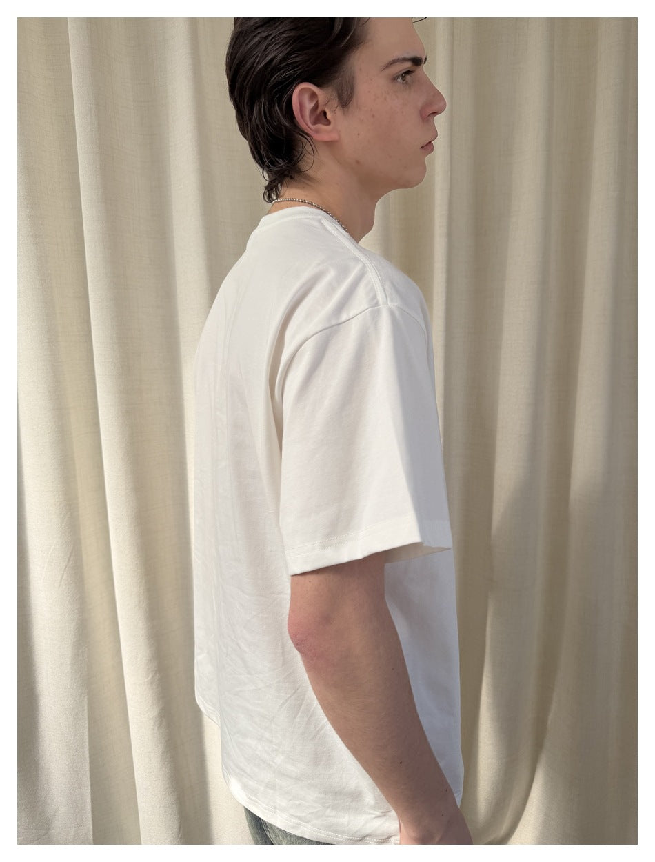 Side view of a model wearing a plain white short-sleeve T-shirt.