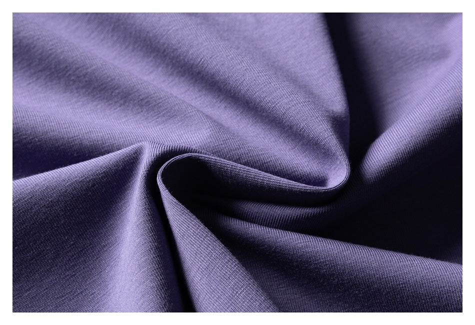 Close-up of softly folded lavender-purple fabric showing its surface texture.