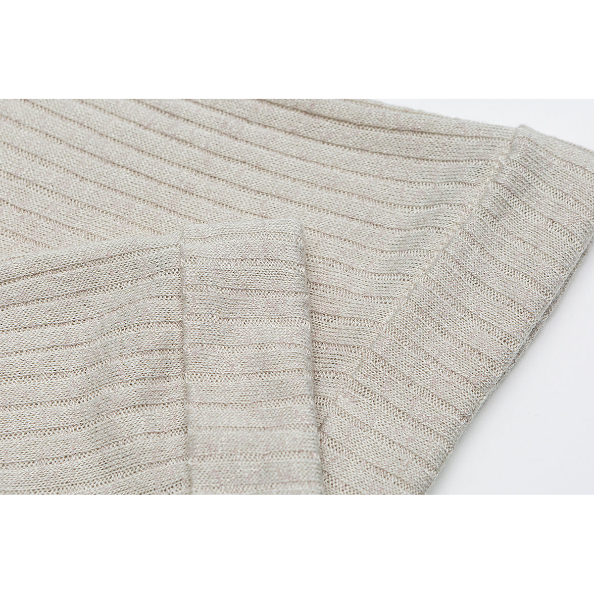 Close-up of the cream shirt’s ribbed knit fabric and short sleeve.