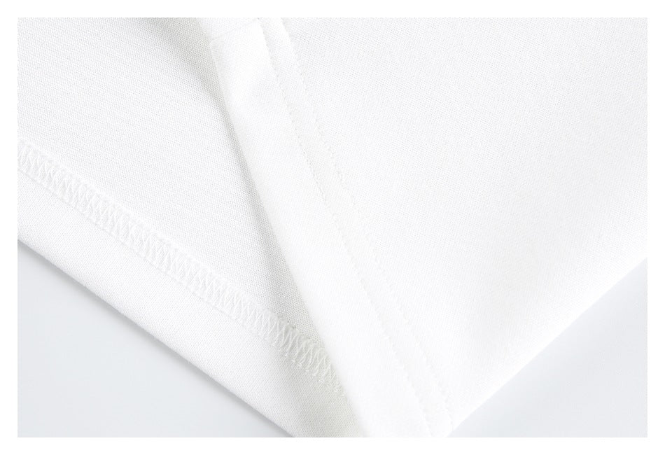 Close-up of white garment interior seam finishing and an overlocked edge.