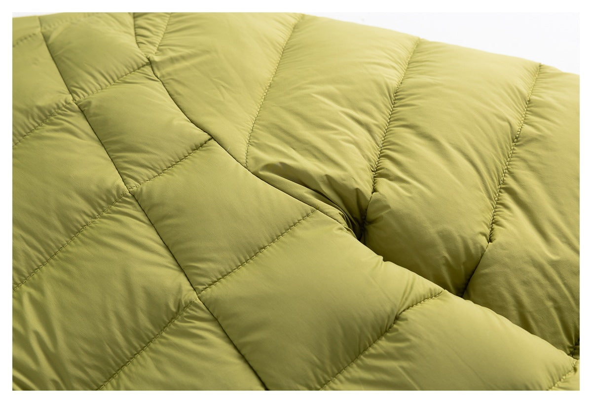 Close-up of olive-green jacket quilting and stitched padded panels.