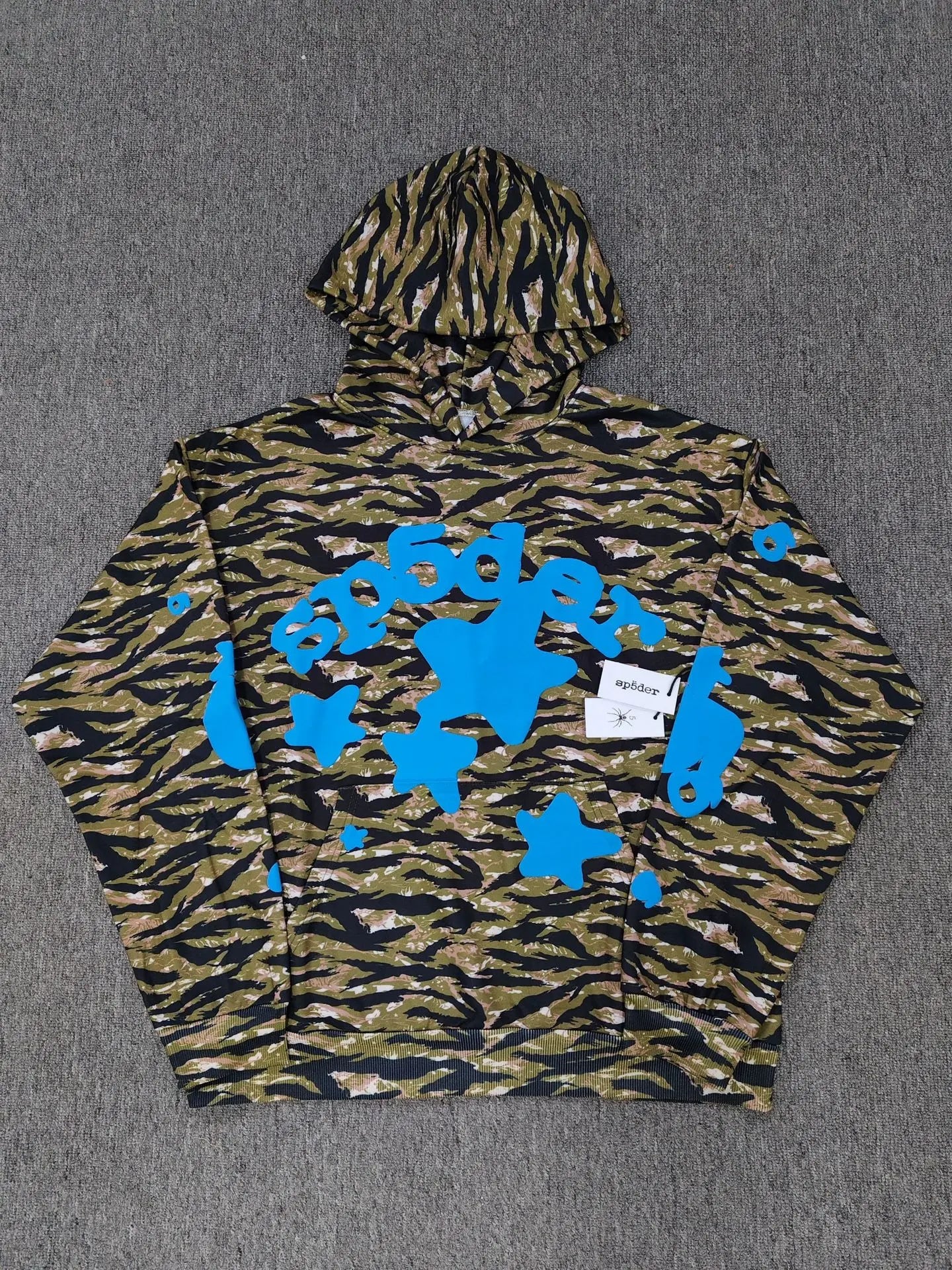 Sp5der camo tiger print pullover hoodie with blue star and lettering graphics on olive black and tan background
