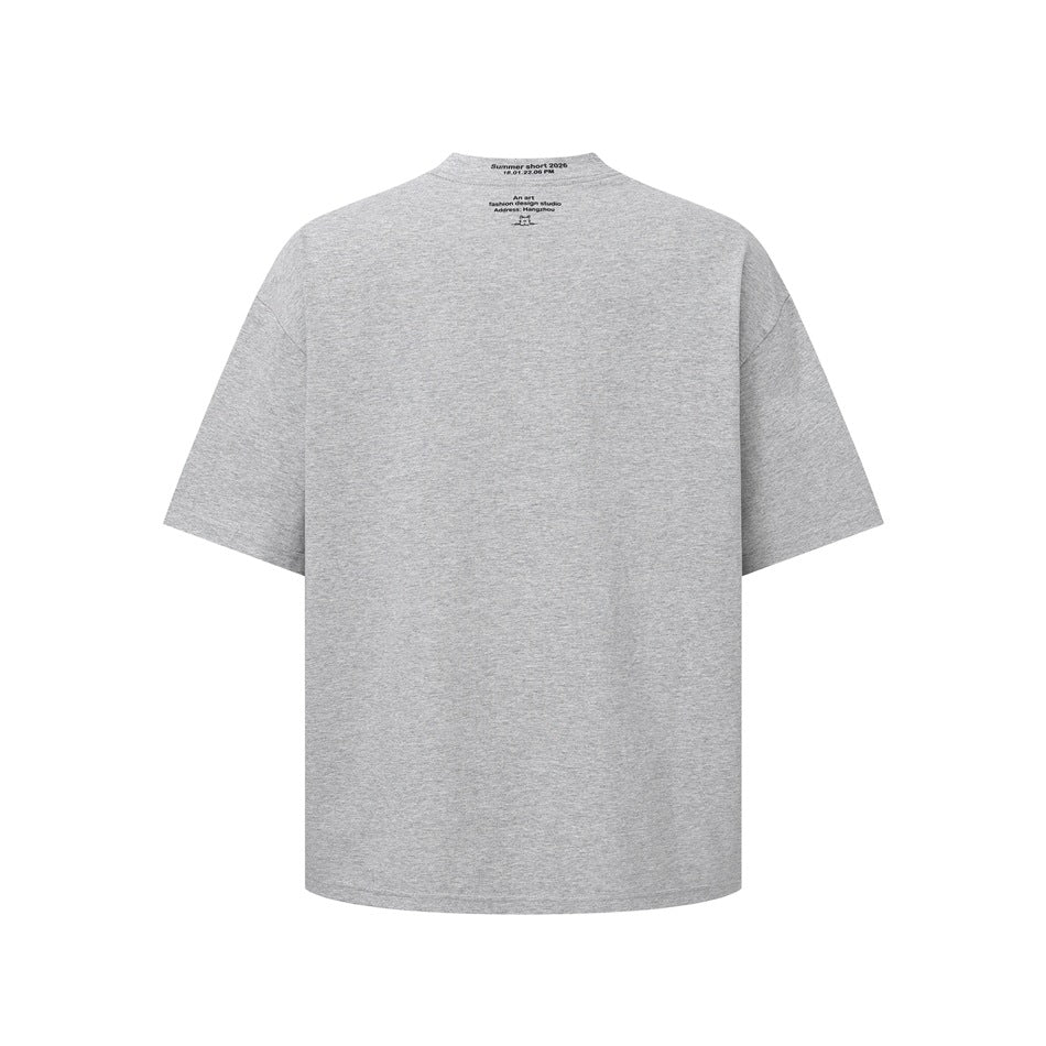 Back view of a heather gray oversized T-shirt with small black text and a tiny graphic below the collar.