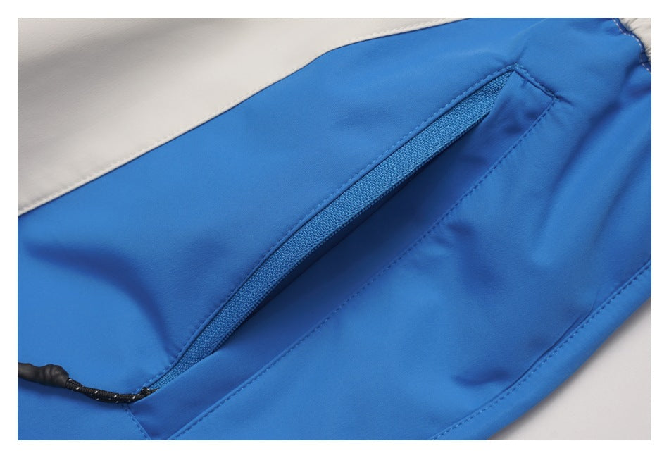 Close-up of a blue zip pocket with a black pull on the pants.