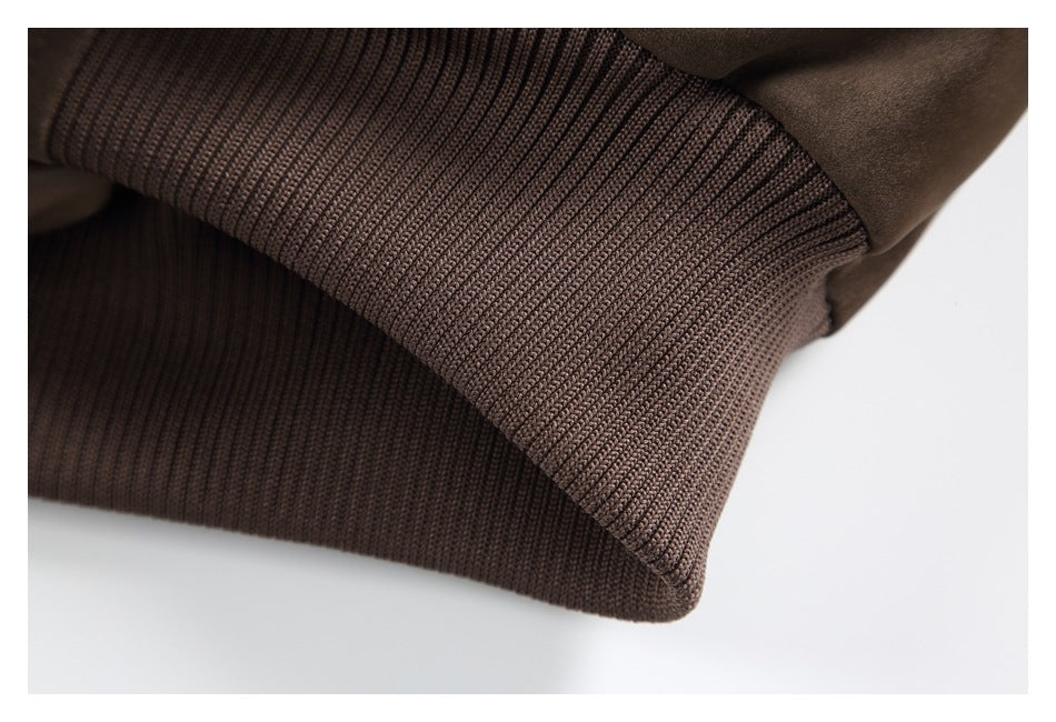 Close-up of a wide ribbed dark-brown cuff or hem on the jacket.