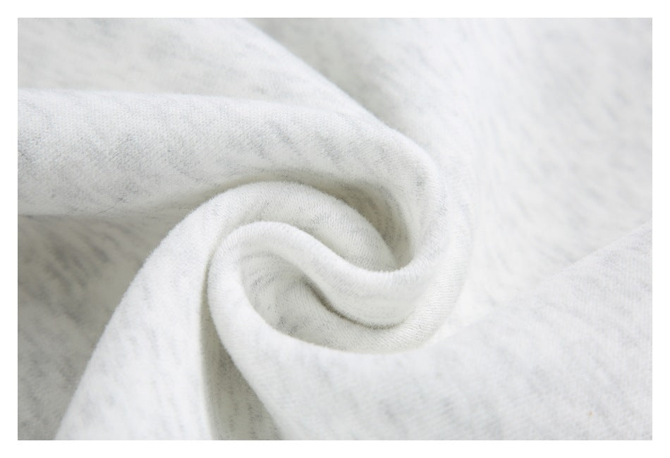 Close-up of light gray marled fabric gathered into a spiral fold.