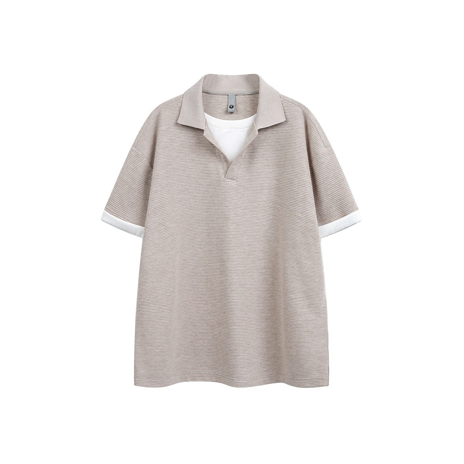 Light khaki short-sleeve textured polo-style top with white layered insert and white cuffs, flat front view