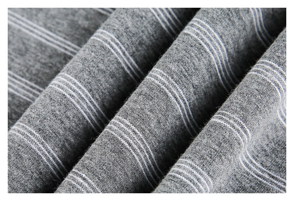 Close-up of gray fabric with thin white stripe bands and a soft, textured surface.