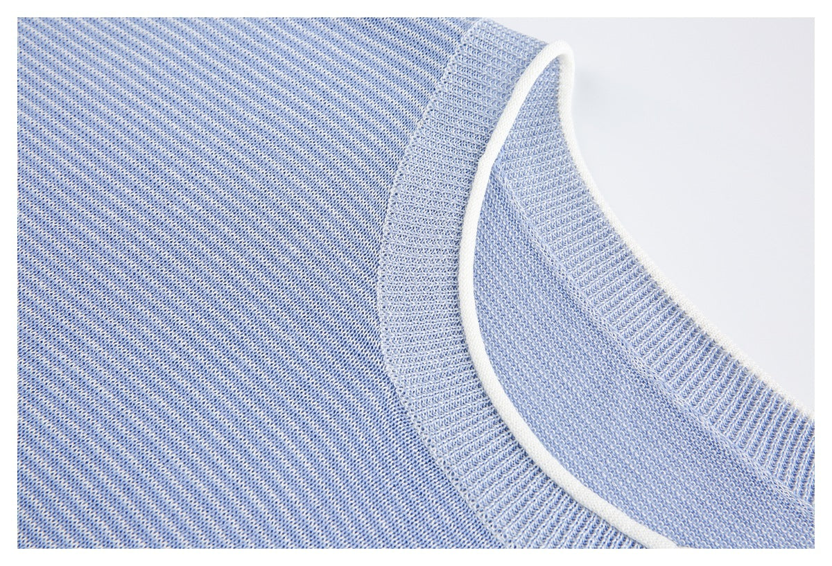 Angled close-up of a light blue knit sweater neckline edged with white trim.