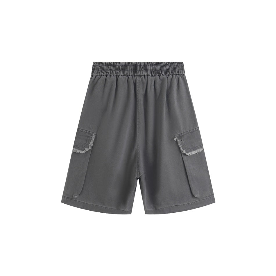 Back view of gray cargo shorts with an elastic waistband and two large side pockets with frayed flaps.
