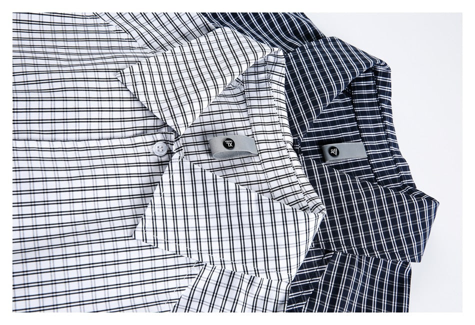 Close-up of white and navy checked shirts showing collars, buttons, and small fabric tabs.