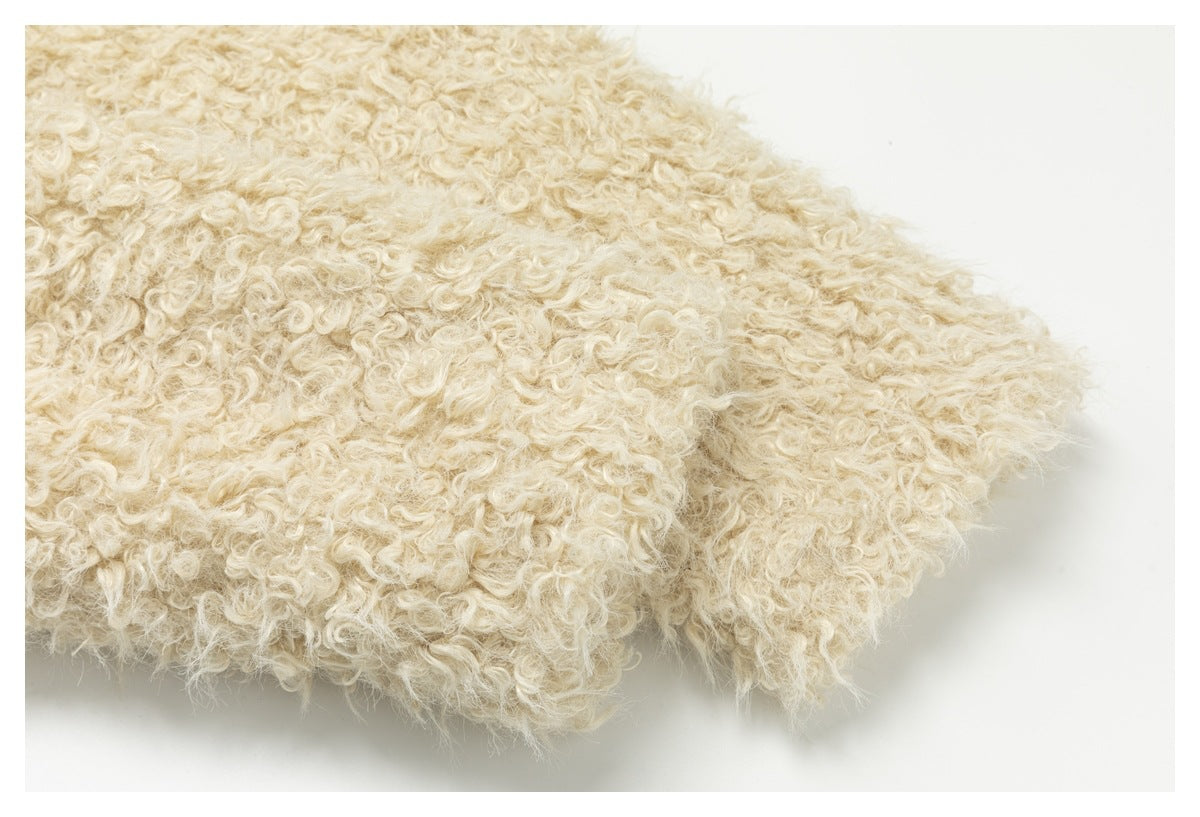 Close-up of cream curly-pile fabric showing a folded, fuzzy edge against a white background.