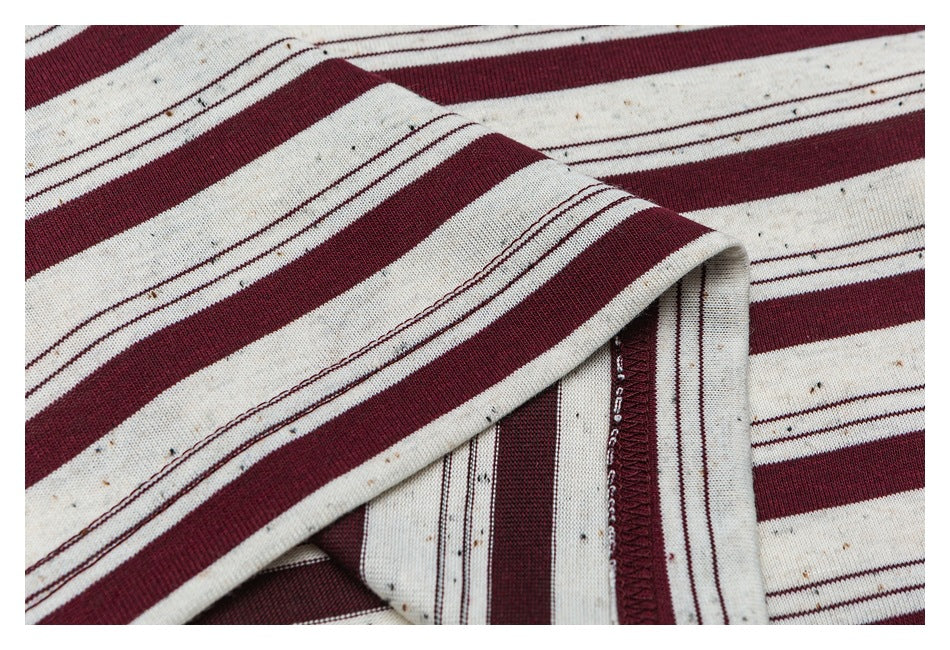 Close-up of the striped shirt's folded sleeve edge and stitching.