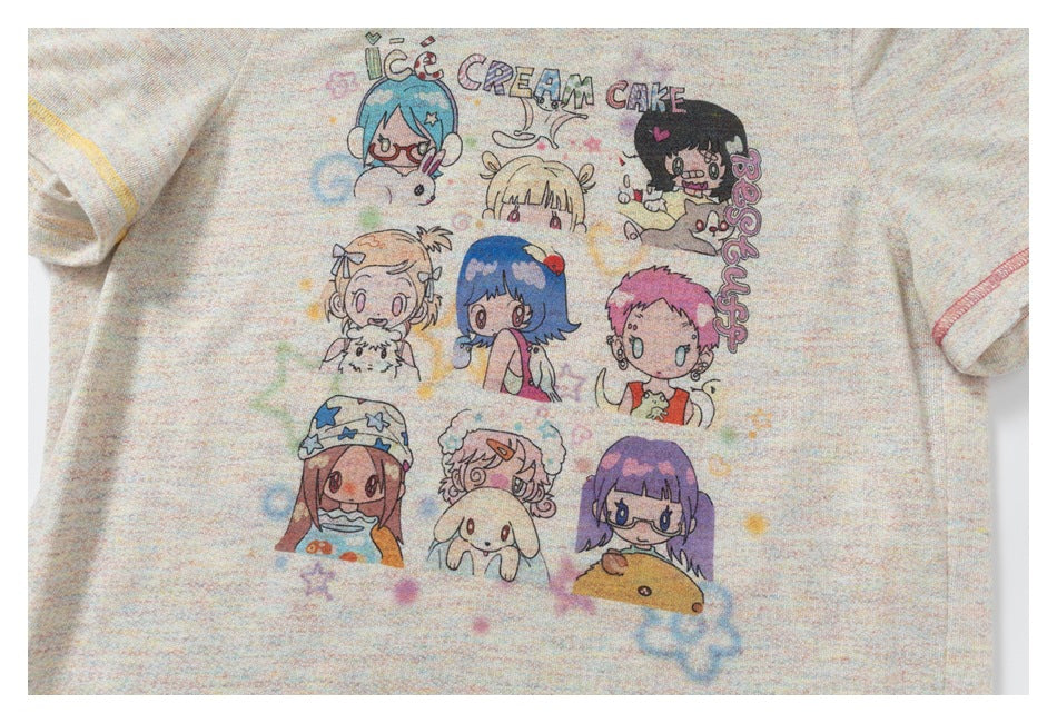 Close-up of a light pastel-speckled T-shirt front with colorful cartoon characters and “ICE CREAM CAKE” artwork.