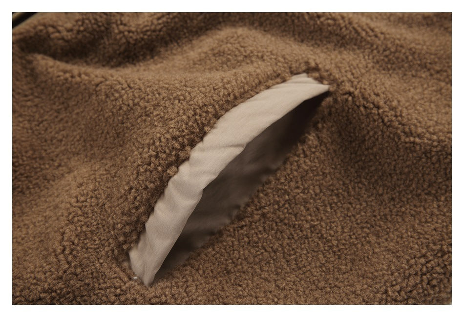 Close-up of an opening in the brown fleece with beige lining visible inside.