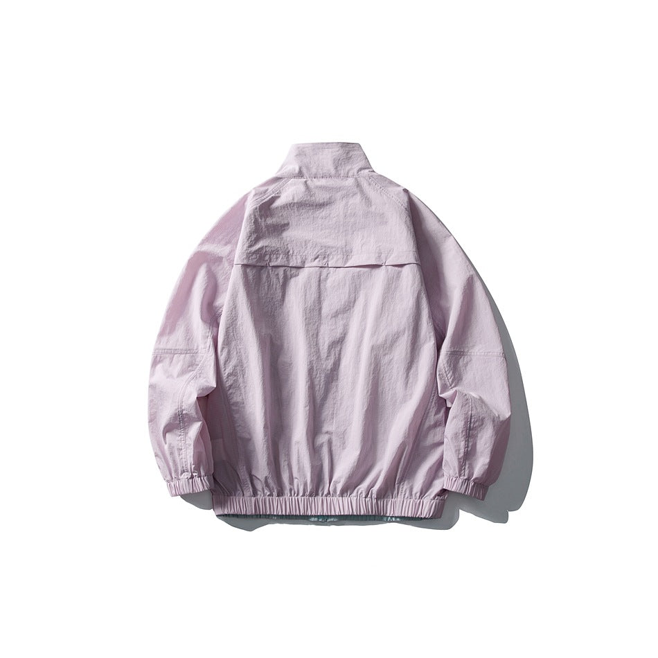 Back view of a light pink stand-collar jacket with a back yoke seam and elastic cuffs and hem
