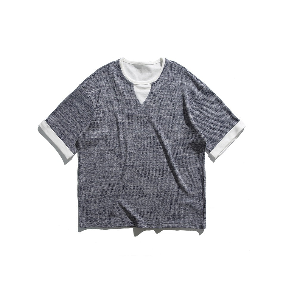 Blue heathered short-sleeve tee with white inner neckline layer, notched V opening and white turned-back cuffs, flat lay