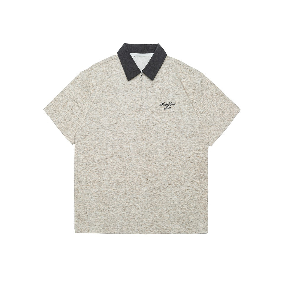 Beige heather gray short-sleeve half-zip polo with dark gray collar and small script embroidery on the chest, flat lay