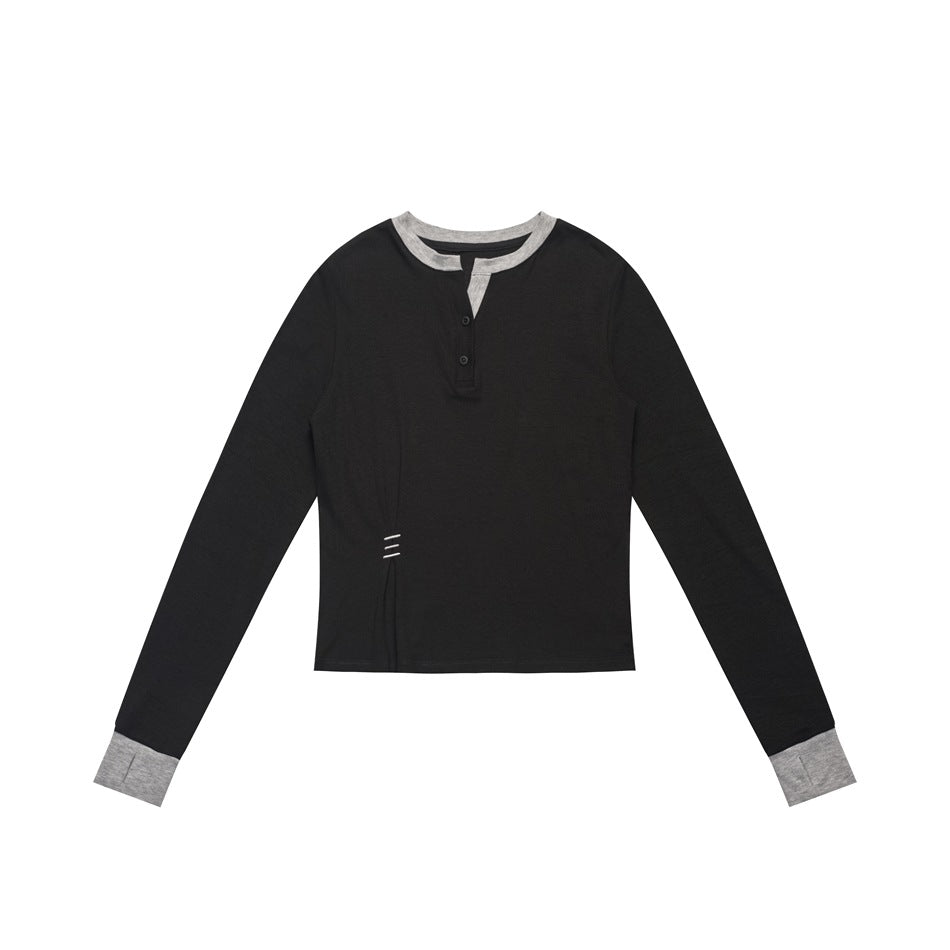 Black long-sleeve henley top with gray collar, placket facing and cuffs, flat lay on white