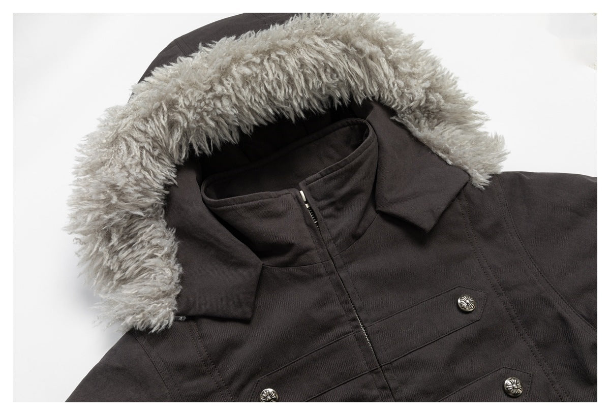 Angled close-up of the parka's gray fur-trimmed hood, high collar, zipper and chest buttons.