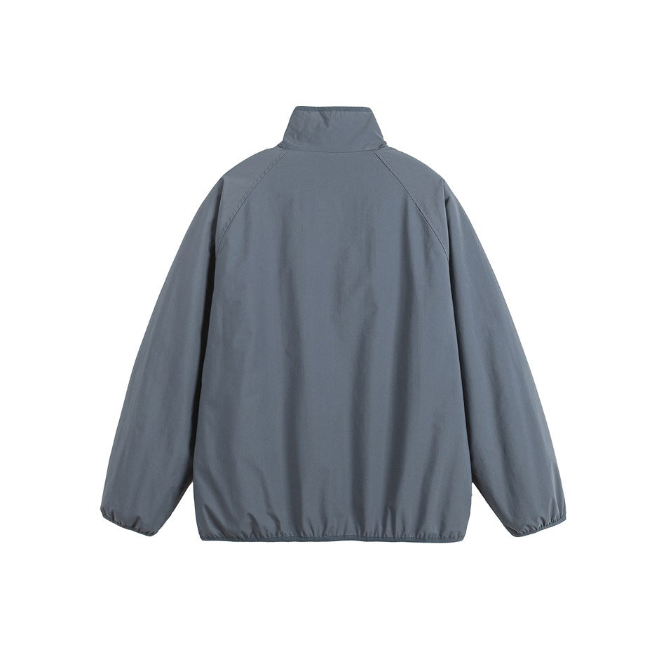 Back view of a dark gray jacket with a stand collar, raglan sleeves, and a plain back.