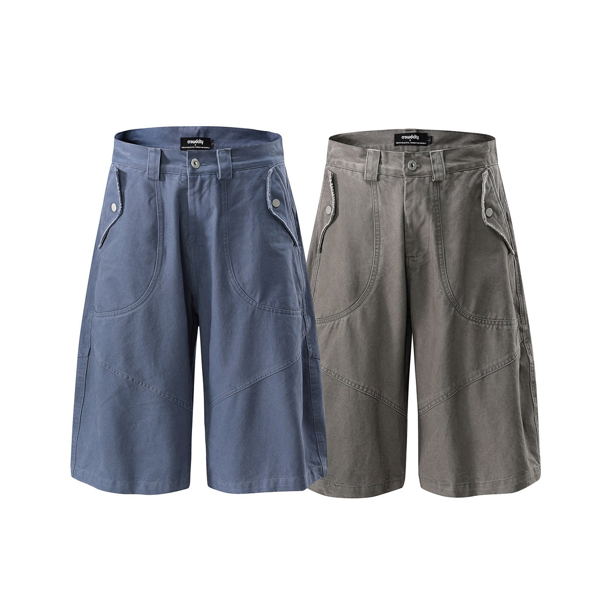 Two pairs of wide-leg shorts shown from the front in muted blue and gray, with curved pockets and snap-button flaps.