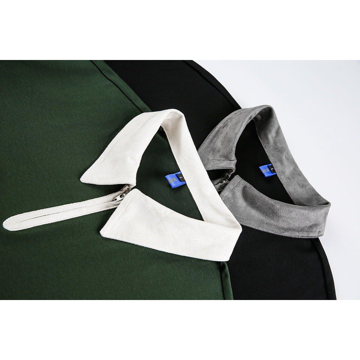 Close-up of the green and black polos' contrasting collars and short front zippers.