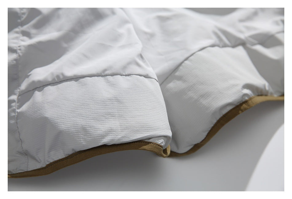 Close-up of the white jacket edge with a wide quilted band and tan-brown binding.