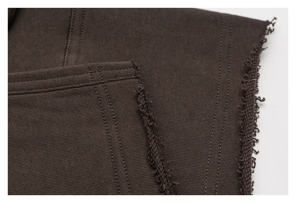 Close-up of dark brown garment seams and exposed, looped raw edges.