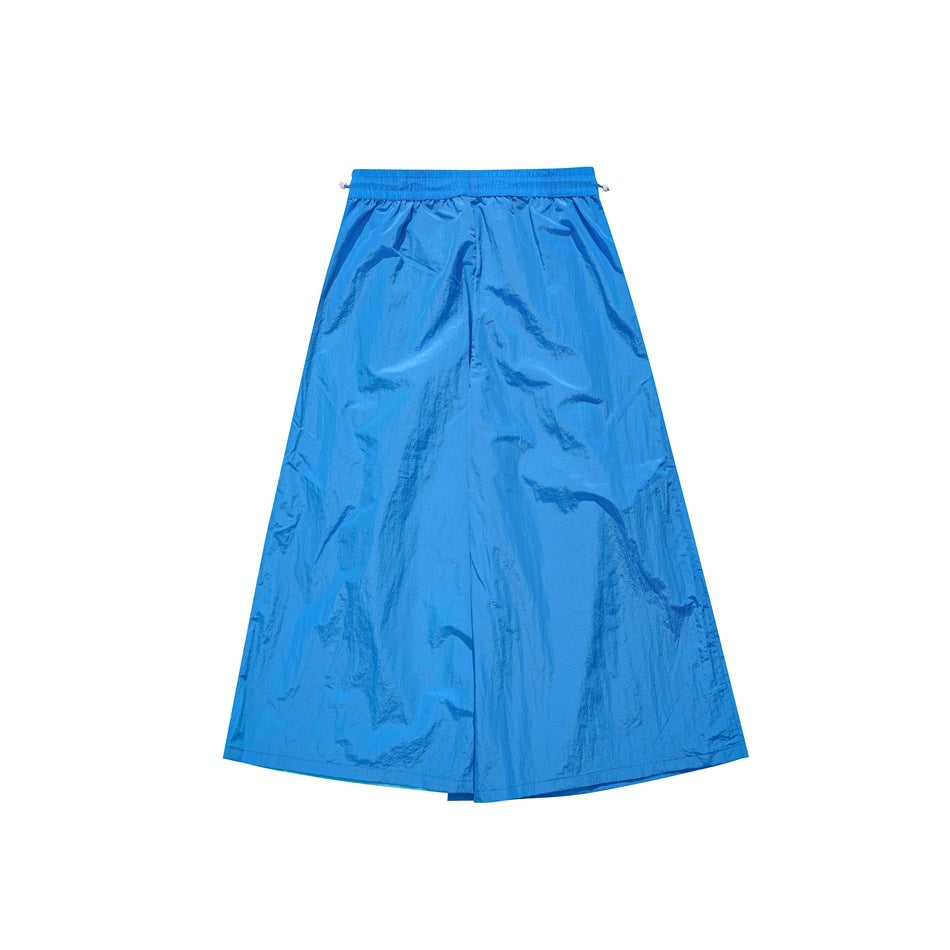 Back view of bright blue wide-leg pants with an elastic waistband and full-length, loose-fitting legs.