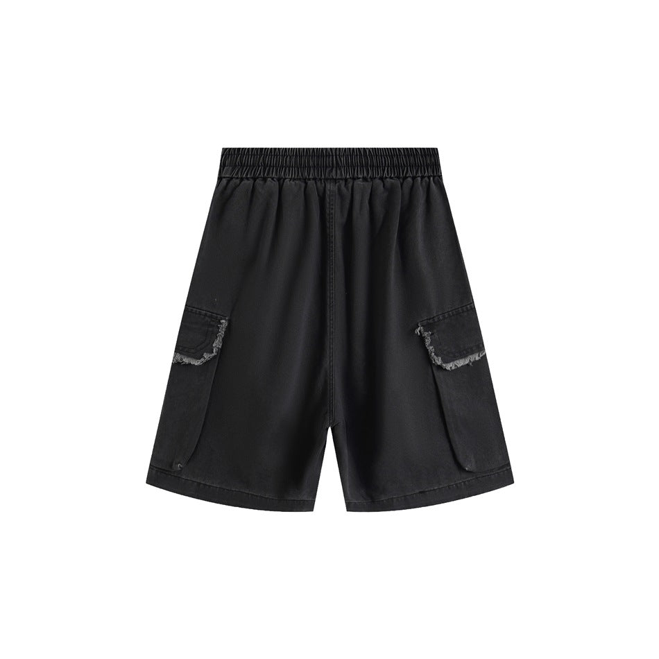 Back view of black cargo shorts with elastic waistband and side cargo pockets with frayed flap edges
