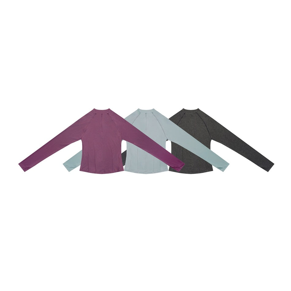 Three long-sleeve tops arranged together in plum, pale blue, and charcoal gray.