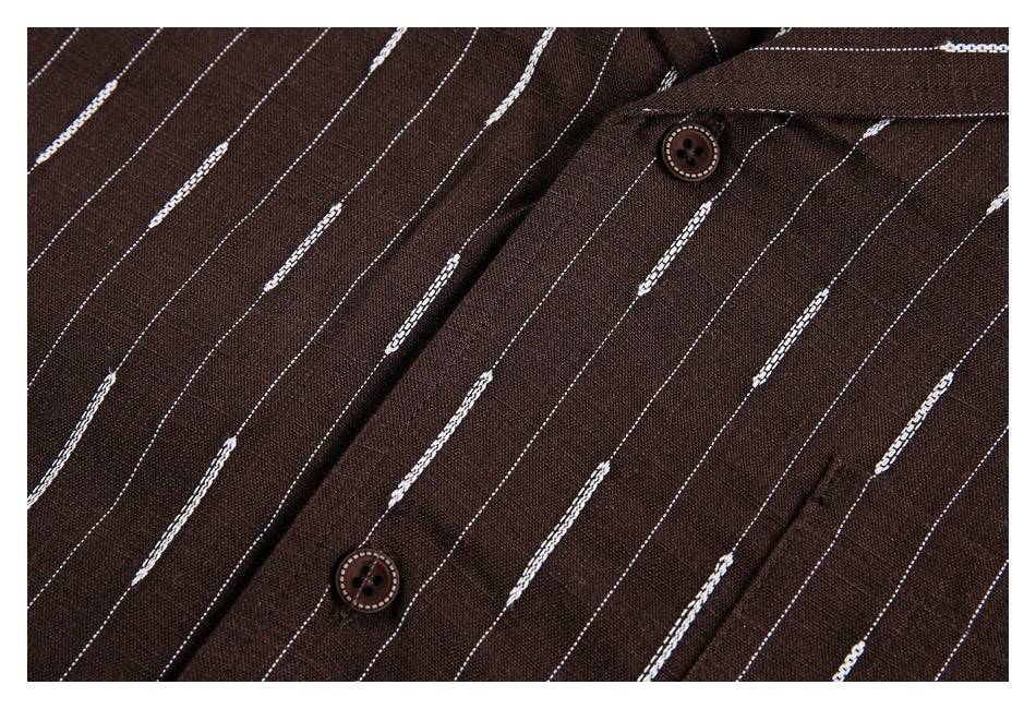 Close-up of a dark brown garment with thin white stripes, a button placket, and two brown buttons.