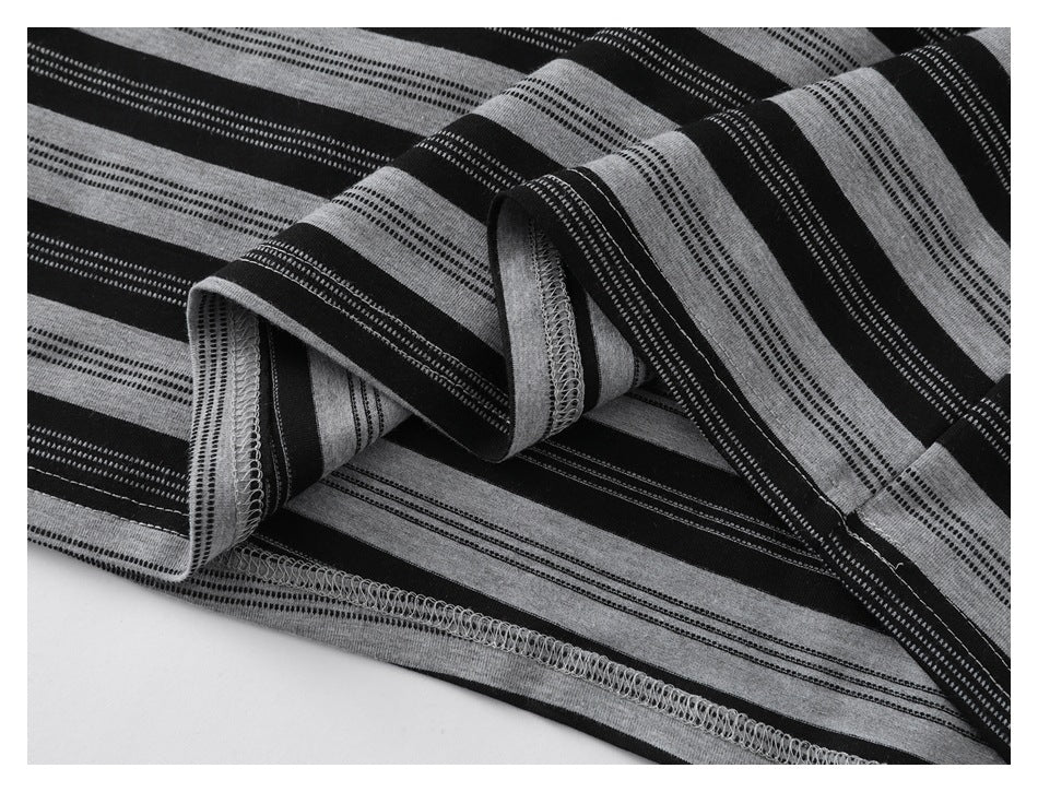 Close-up of the striped shirt's folded hem and overlocked stitching.